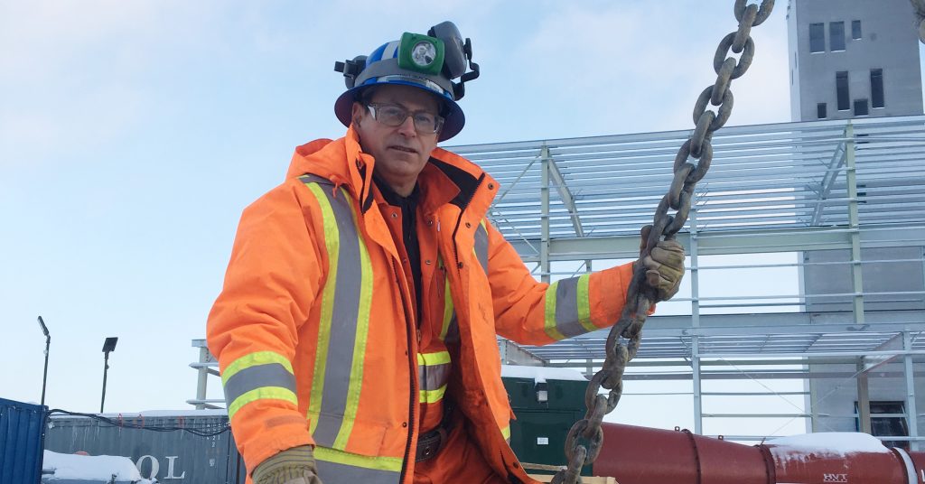 Cementation Americas director, Roy slack, entering a bucket o site in full high-viz PPE.